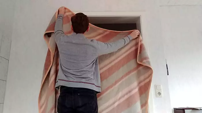 add a wool blanket to keep heat in a room without a door